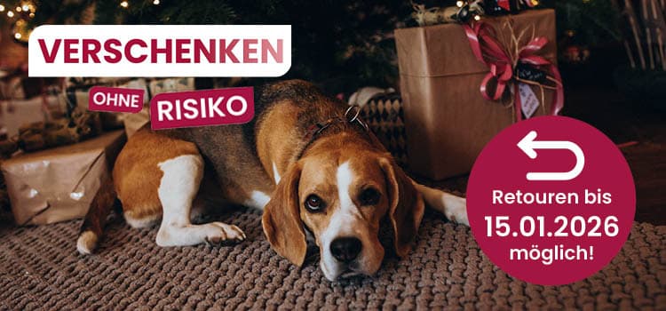Verschenken ohne Risiko – Retournieren bis 15.01.2026 möglich! Hund liegt vor Geschenken unter einem Weihnachtsbaum
